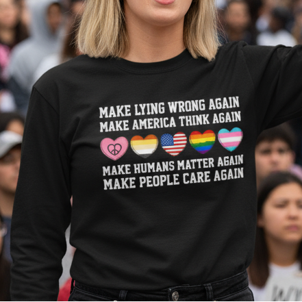 Woman holding a protest sign in a crowd with 'Unity & Truth Now!' text