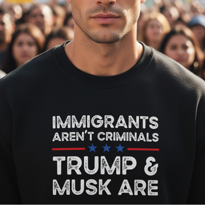 Person wearing a black sweatshirt with a political message in front of a blurred crowd.