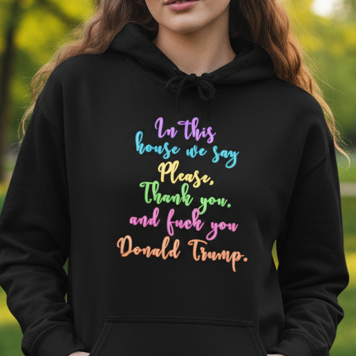 Person wearing a black hoodie with colorful text in a park fdt